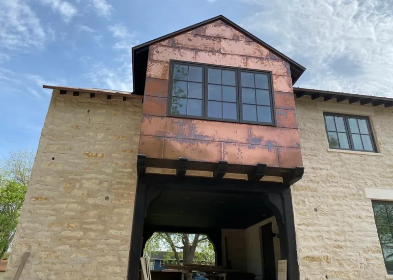 Copper metal panel facade on a stone building for Skylight Installation in Tracy